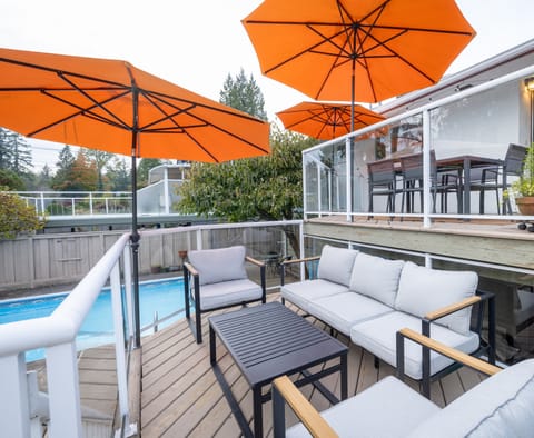 View to large heated pool from lower-level terrace deck with conversation set