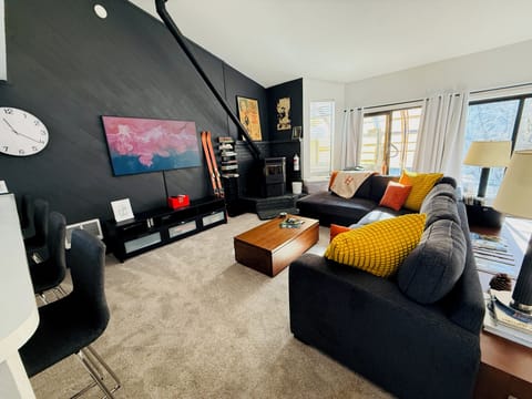 Warm and inviting living room with 62" TV access to private spa and small deck.