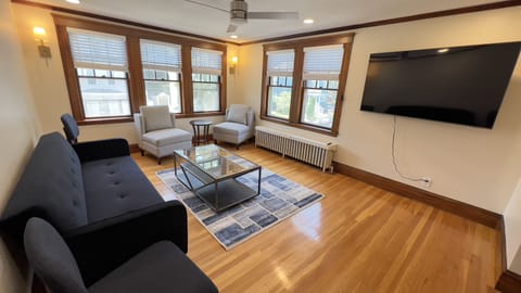 Living Area, convertible sleeper lounger. 60" Smart TV.