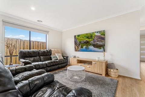 Open plan living room with flat screen TV.
