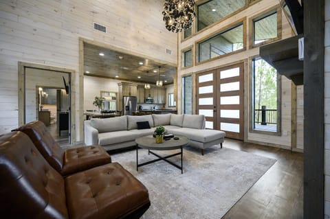 Step into the inviting ambiance of this cabin’s living room, where the beauty of nature seamlessly meets cozy, stylish design 🌲