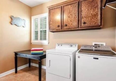 Full-Size Washer/Dryer, Folding Table, Hanging Rod, Shelving & Extra Cabinetry 