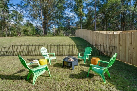Patio for four with Adirondack chairs and fire-it in a large fenced lawn