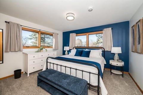 Blue themed bedroom with king size bed.