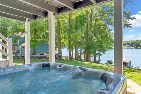 Take a relaxing dip in this hot tub with a beautiful view of the lake.