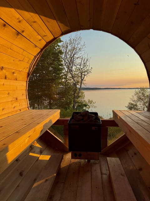 Golden hour hits different when you’re tucked inside the warmth of the sauna, watching the sun melt into the turquoise waters of Crystal Lake.