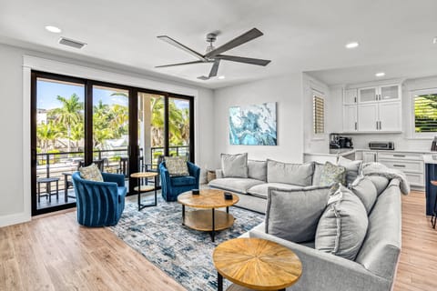 2nd Level Living Room with kitchen and balcony view.
