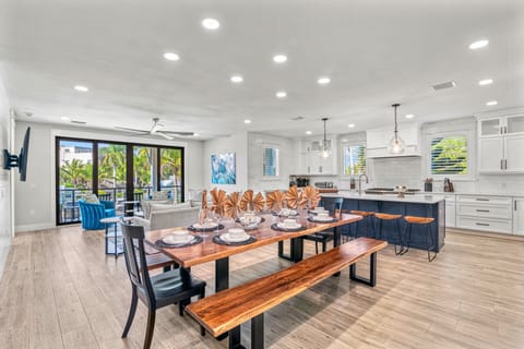 2nd Level Living, Dining with Kitchen and patio slider to the balcony in view.