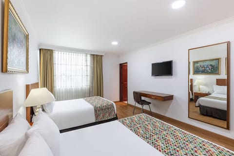 Stretch out in a bright room with TV and workspace.