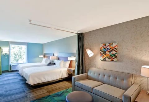 Relax together with cozy sofa seating beside crisp, inviting beds.