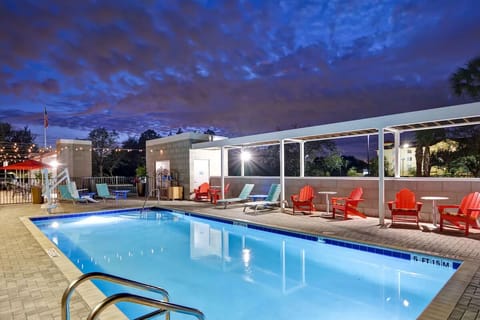 Relax under glowing lights with an inviting evening swim.