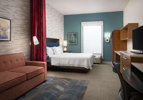 Settle in with a comfy bed and productive work zone.