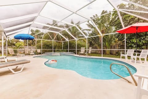 The pool is located within a screen enclosure and has plenty of lounge and pool side chairs for pool side relaxing and entertainment.