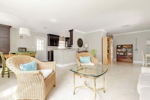 Secondary seating area with working desk next to dining and kitchen area.