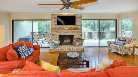 This inviting living space combines comfort and character with a classic brick fireplace as the focal point.