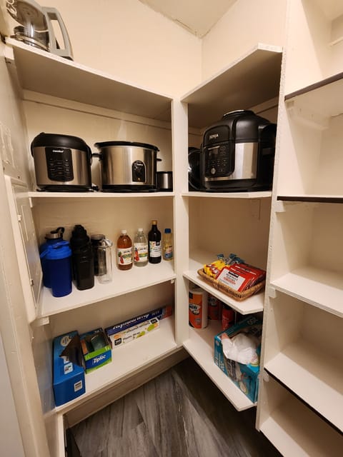Pantry with small appliances and other kitchen amenities.