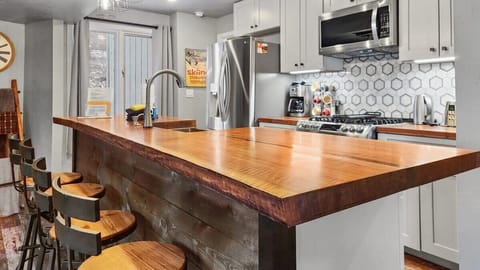 The kitchen is an ideal blend of style meets function with gorgeous wood countertops providing a beautiful style to the space and ample room for meal prep.
