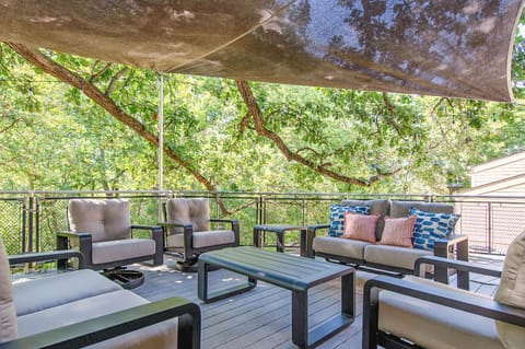 Unwind in your private covered terrace, where plush seating and dappled sunlight create the perfect retreat for morning coffee or evening relaxation.