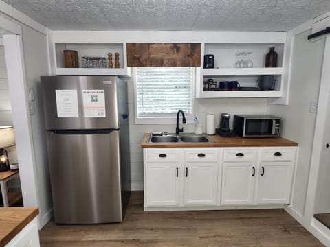 Full size Fridge, Sink, Microwave, Coffee Maker, Dishes.