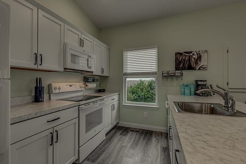 Kitchen includes coffee bar with coffee, sugar, creamer, and tea provided.