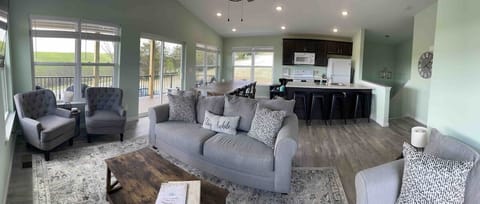 The great room, equipped with a smart TV, dining room seating for 10 (plus four bar stools at the counter), a fully stocked kitchen, and complimentary coffee bar.