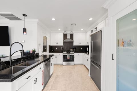 Modern kitchen w/ sleek counters, ample cabinetry & a clean, functional layout.