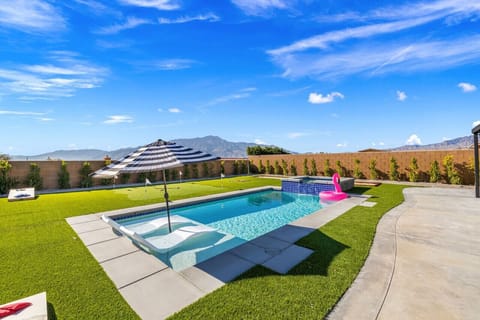 Sun-soaked backyard w/ private pool, spa & wide lawn—perfect for cooling off, lounging, or gathering outdoors.