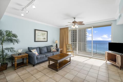 Relax in this bright living room with ocean views and direct balcony access.