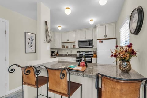 A bright and well-equipped kitchen provides everything you need to prepare delicious meals at home including updated appliances and a kitchen bar.
