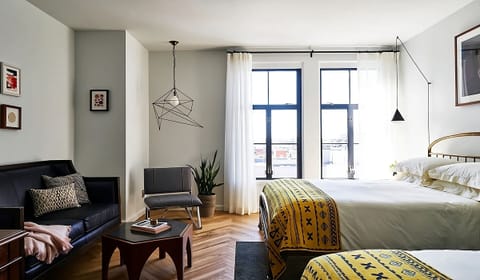 Unwind in a sunlit suite with cozy lounge seating.