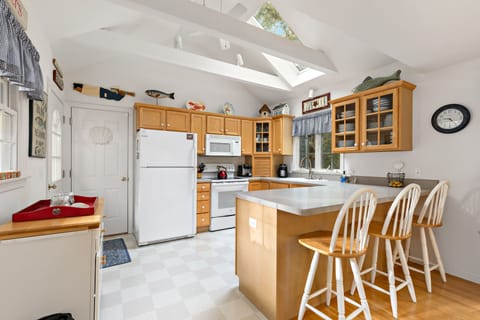 The eat in kitchen is well lit with gorgeous skylights