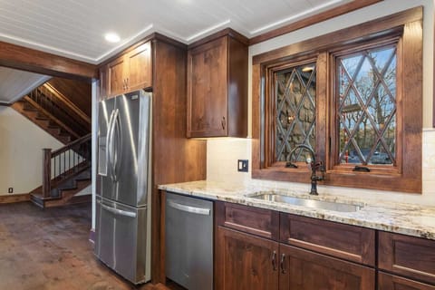 Large Fridge and Basin Sink in the Kitchen. There is an Additional Fridge and Ice Maker Off the Kitchen in Laundry Room