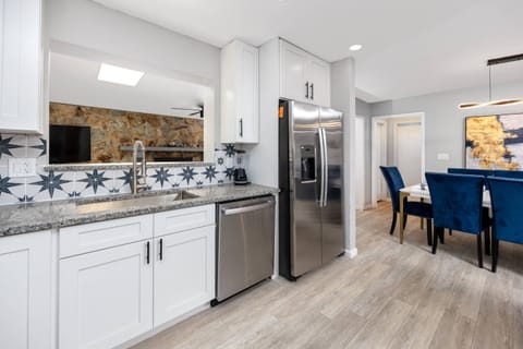 Kitchen Features a Pass-Through Window to the Family Room