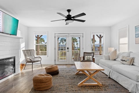 Living Room with comfortable seating, partial Gulf views, 55” Smart TV, and gas fireplace