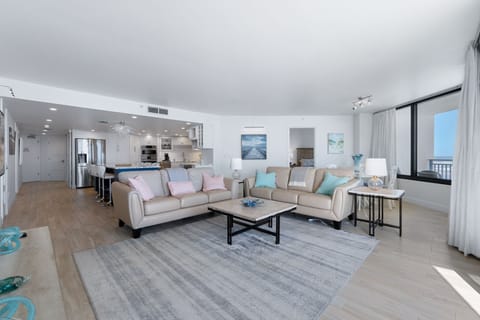 A spacious sofa positioned to enjoy the beachfront panorama.