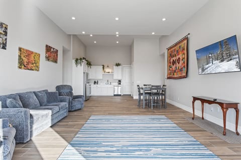 Massive family room with recliner couches and love seats, 20' ceilings