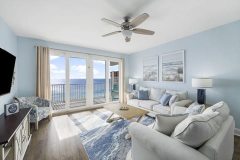 Relax in this coastal living room with ocean views through large glass doors.