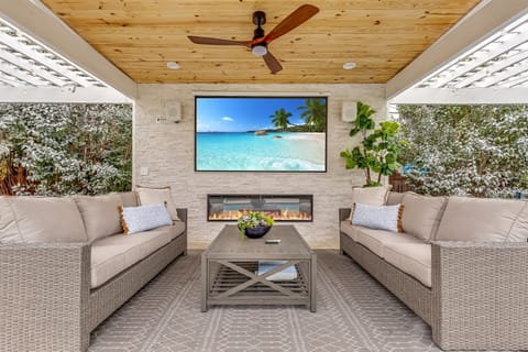 Revel in the comfort of this chic lounge space, where modern design meets home theater under the stars.