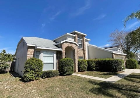 Cozy and welcoming exterior with manicured lawn and ample parking.