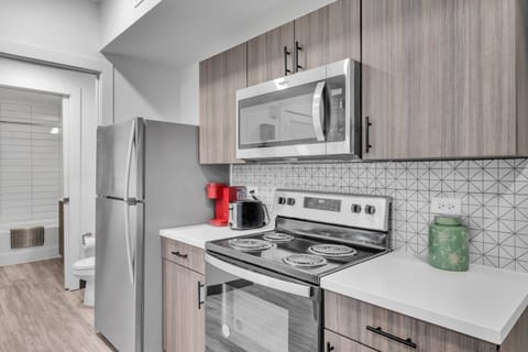 Kitchen includes a refrigerator, microwave, Keurig pod coffee maker, toaster, electric plug-in cooktop & many more!