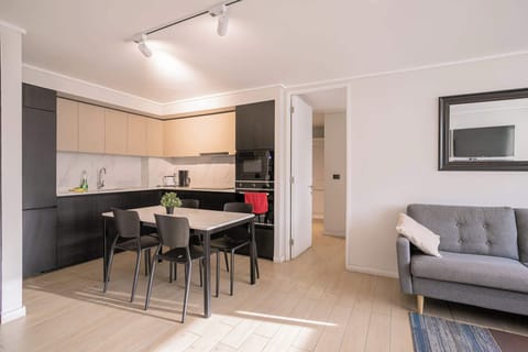 Experience modern living in this stylish kitchen and dining area, perfect for cozy meals and relaxation.