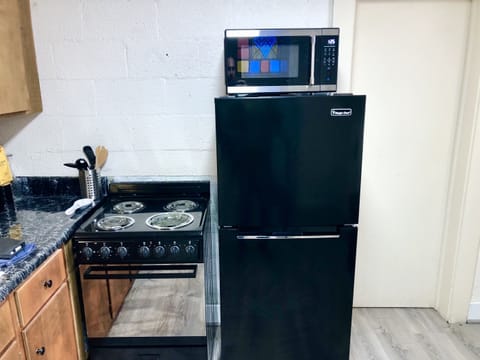The kitchen is a cozy spot for making meals and memories - bathed in the morning light of stained glass (peep the reflection)!