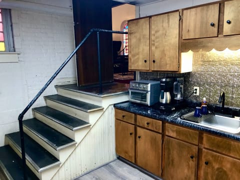 The kitchen is tucked to the side of the main sanctuary, just down a short set of wide steps and just off the sitting area with its television and electric fireplace for relaxing.  When you're relaxing, a snack or a cup of hot cocoa are just steps away.