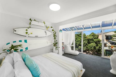 Sea-themed master bedroom with king bed and panoramic ocean views