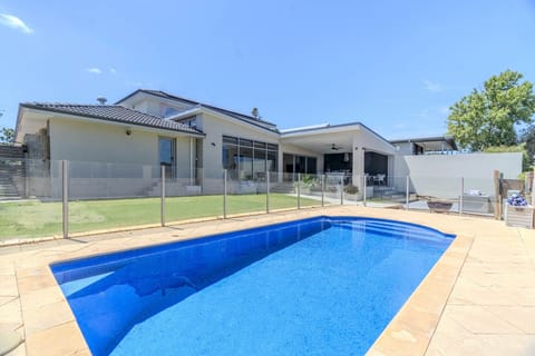 Fenced Pool and Patio: Relaxed Outdoor Living with Al Fresco Dining