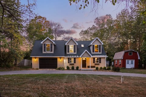 Charming lakefront home with a welcoming front view and natural surroundings.