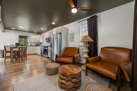 Spacious living room with leather sofa and cozy gathering space.