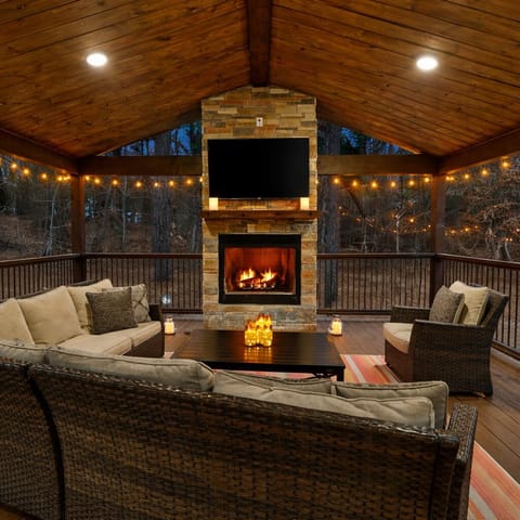 Covered porch with fireplace — your go-to spot for cozy evenings year-round