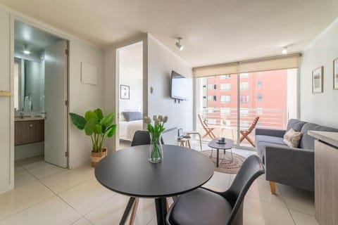 Bright and modern living space with balcony access, perfect for relaxing and enjoying city views.