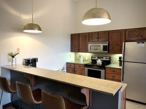 Extra seating at the bar and dining table provides areas to eat, game, or just hang out. 